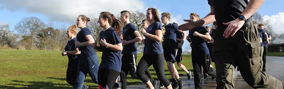 Uniformed services students running